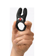 Czarny pierścień wibracyjny Fun Factory w dłoni, z czerwonym przyciskiem i silikonowym wykończeniem