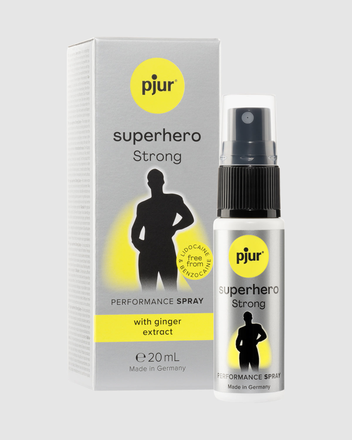 Biały flakon z pompką i szare pudełko z żółtym logo marki Pjur, spray 20ml z ekstraktem z imbiru